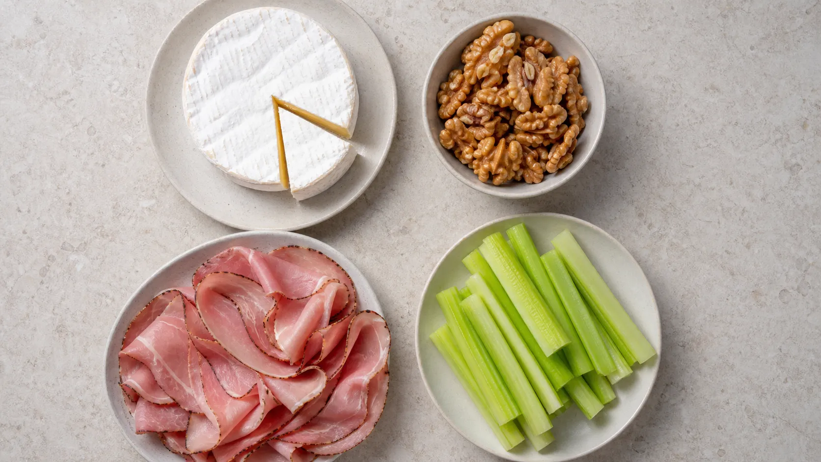 Ingredients for keto Camembert walnut ham plate with Camembert, walnuts, ham and celery