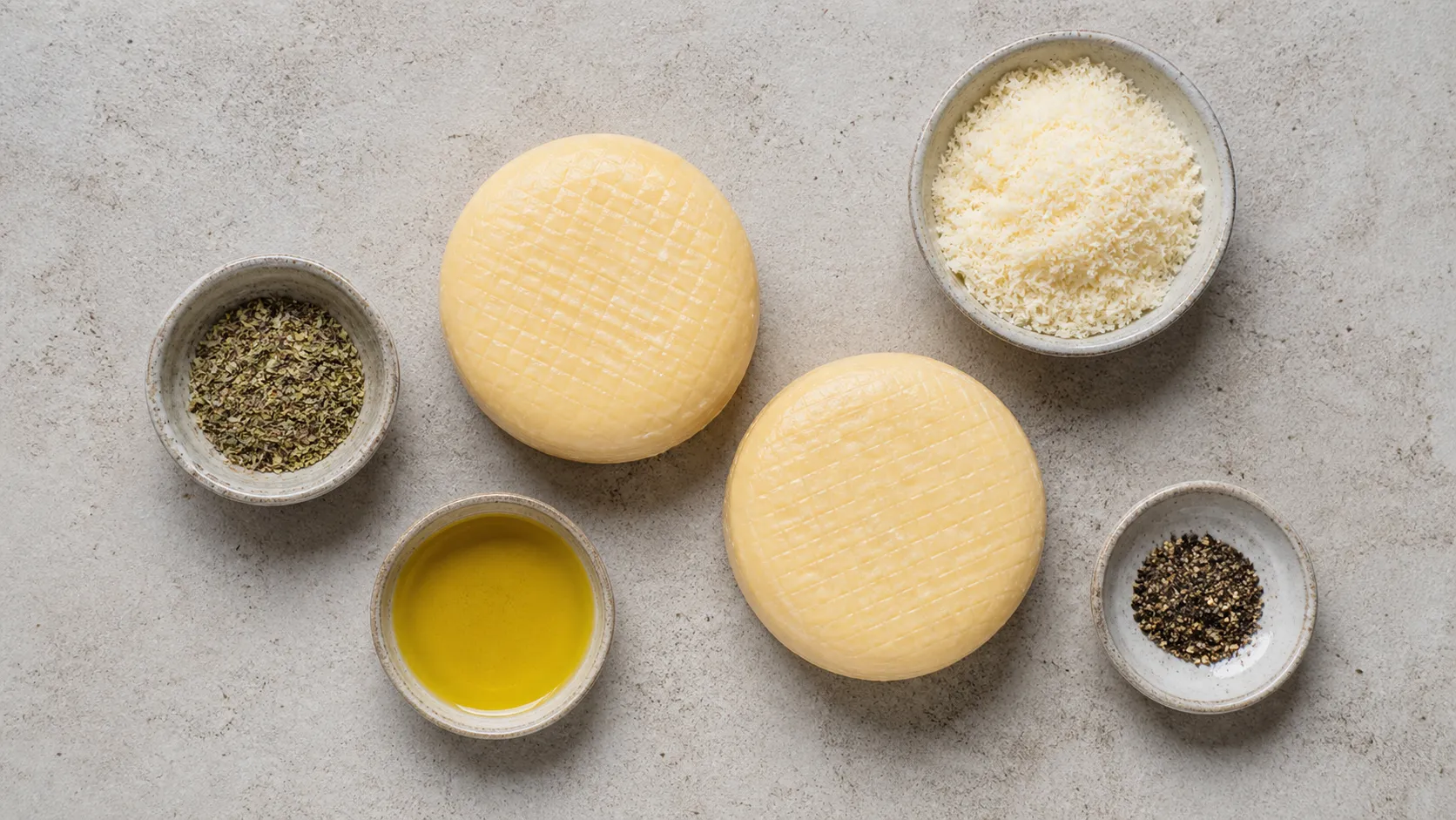 Ingredients for handkase in the air fryer: handkase, parmesan, herbs, olive oil