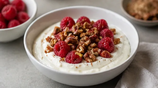 Keto mascarpone breakfast with raspberries and toasted pecans in a bowl