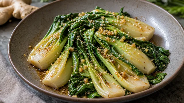 Keto bok choy with sesame seeds, ginger, garlic and glossy tamari sauce in a wok