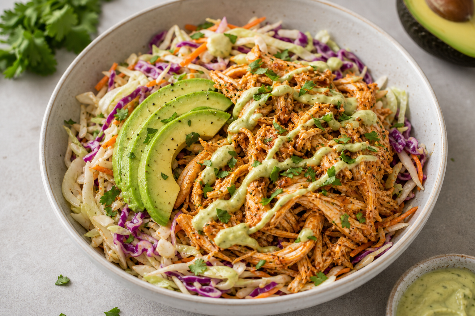 Keto pulled chicken bowl with colorful coleslaw, avocado and smoked paprika in a bowl