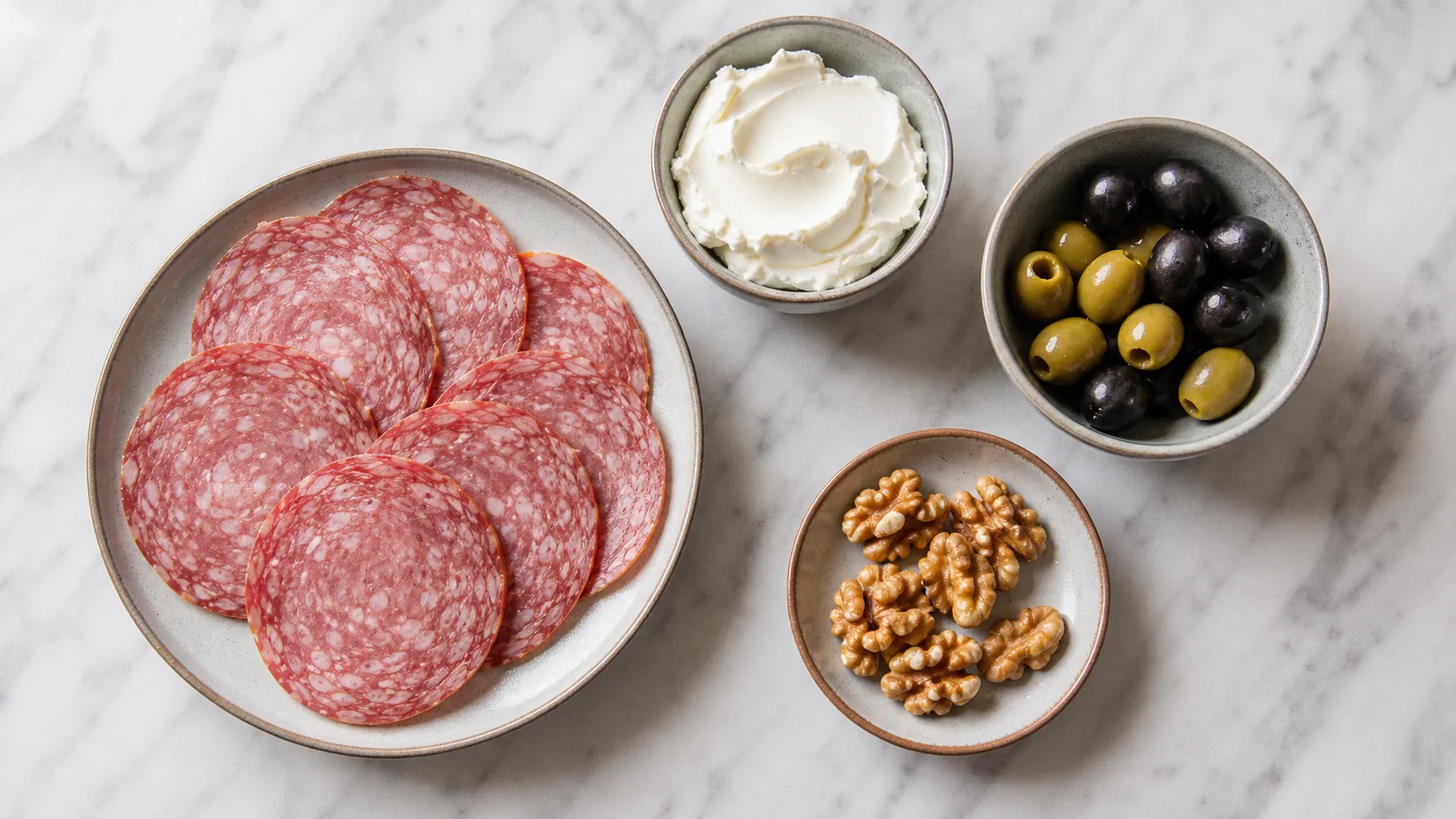 Ingredients for the keto salami, cream cheese and olive plate: salami, cream cheese, olives, walnuts