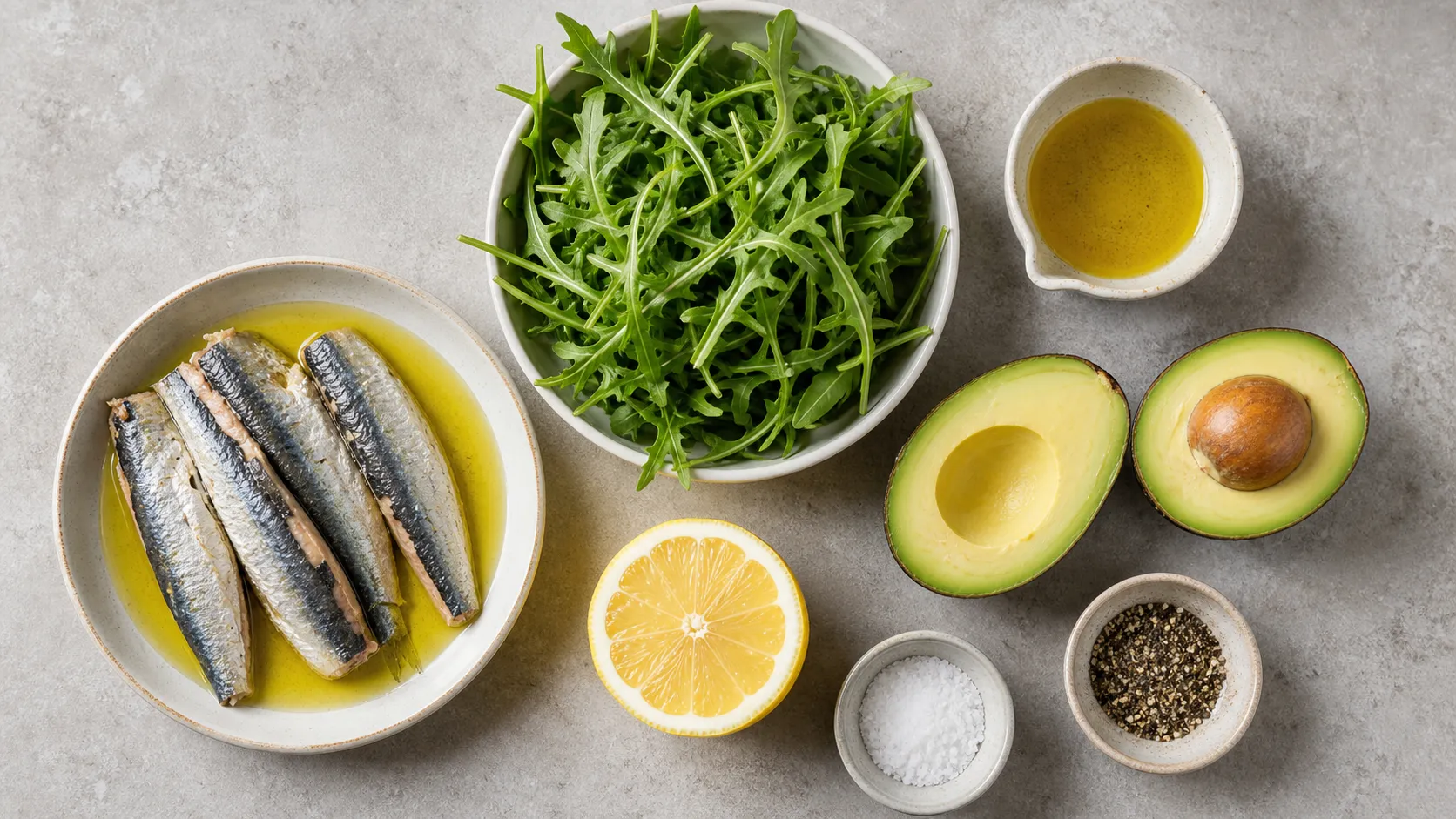 Ingredients for keto sardines avocado salad with sardines, avocado, arugula, lemon and olive oil