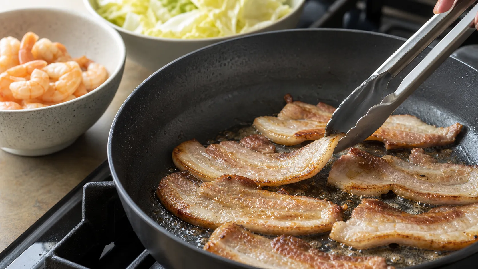 Preparation step for Keto Pork Belly Asian Salad with Shrimp: 50 g Protein: Pat the pork belly slices (150 g) dry. Place them into a dry, very hot pan (no oil). Sear for 4 to 5 minutes per side over medium-high heat until golden brown and lightly crisp. Remove.